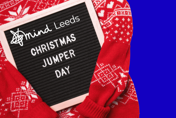 Christmas jumper and text board reading 'christmas jumper day, with Leeds Mind logo